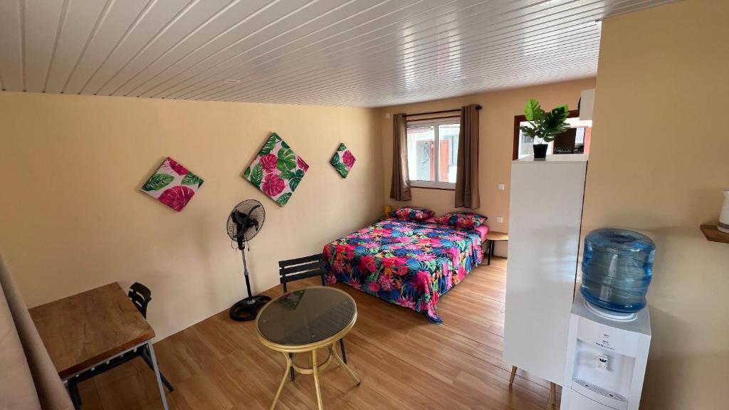 a bedroom with a bed and a table in a room at Hiti Village G3 in Tikehau