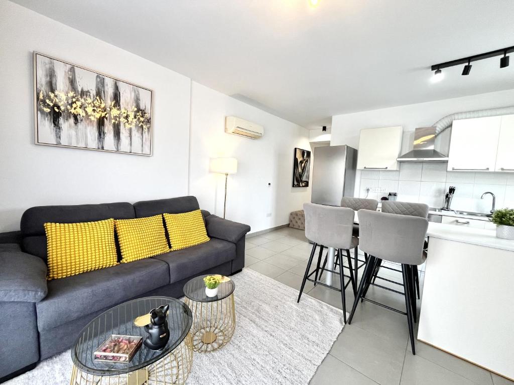 a living room with a couch and a kitchen at STAY Sun Line Apartment in Nicosia