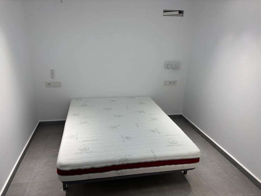 a bed in a room with a white mattress at Llano Urban Park in Murcia