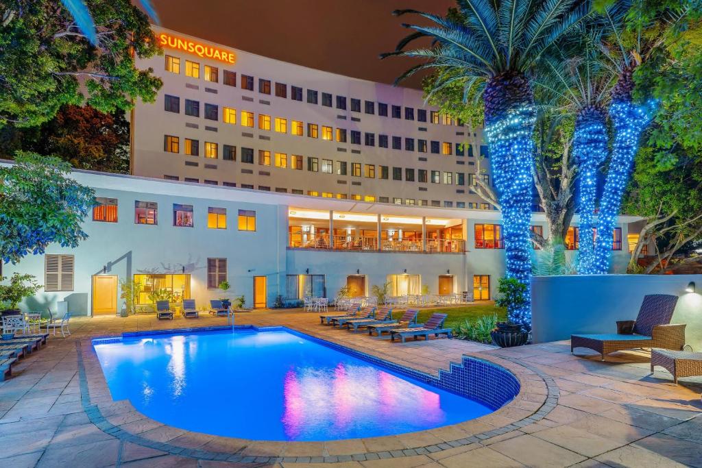 a hotel with a swimming pool in front of a building at SunSquare Cape Town Gardens in Cape Town