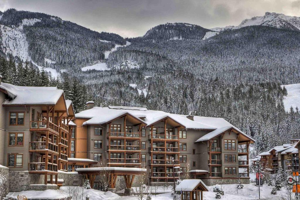 a large apartment building with snow on the roof at Lodging Ovations in Whistler