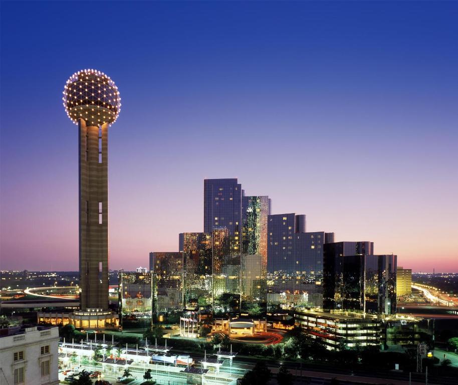 a city skyline at night with a tall tower at Hyatt Regency Dallas in Dallas