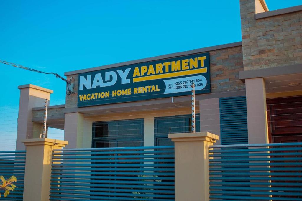 a building with a sign for a mercy apartment at Nadyapartment in Dodoma