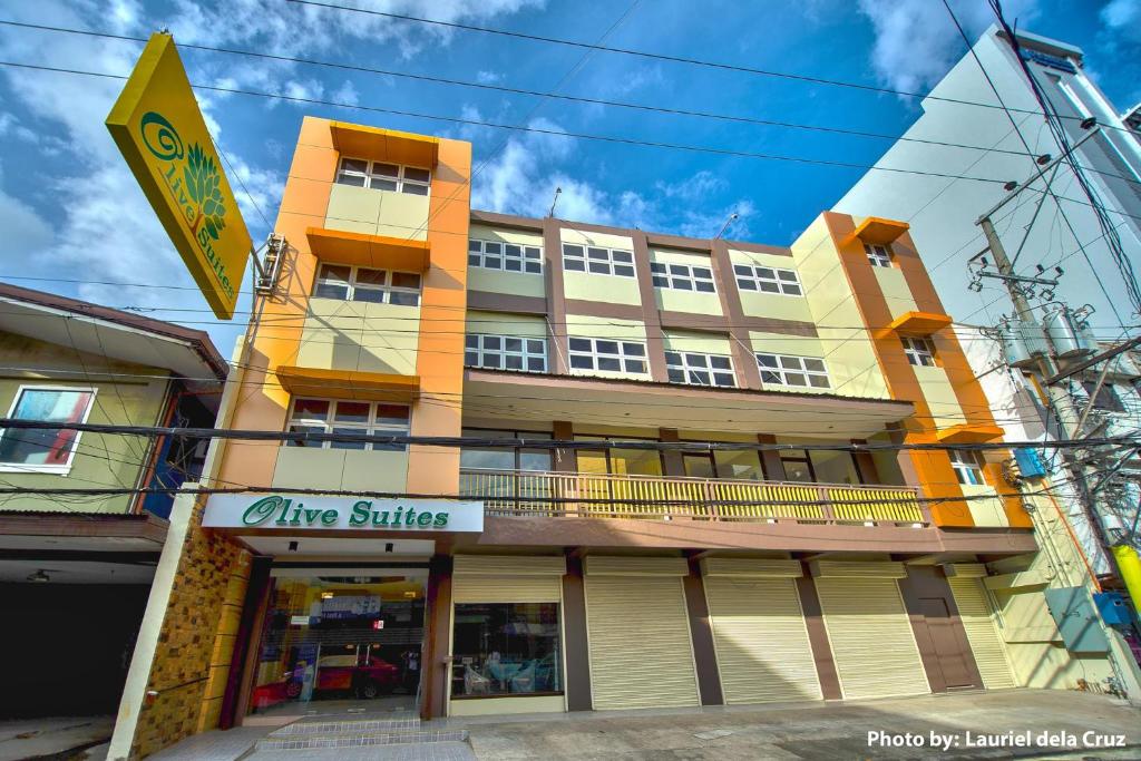 a orange building with a white and yellow building at Olive Suites in Cagayan de Oro