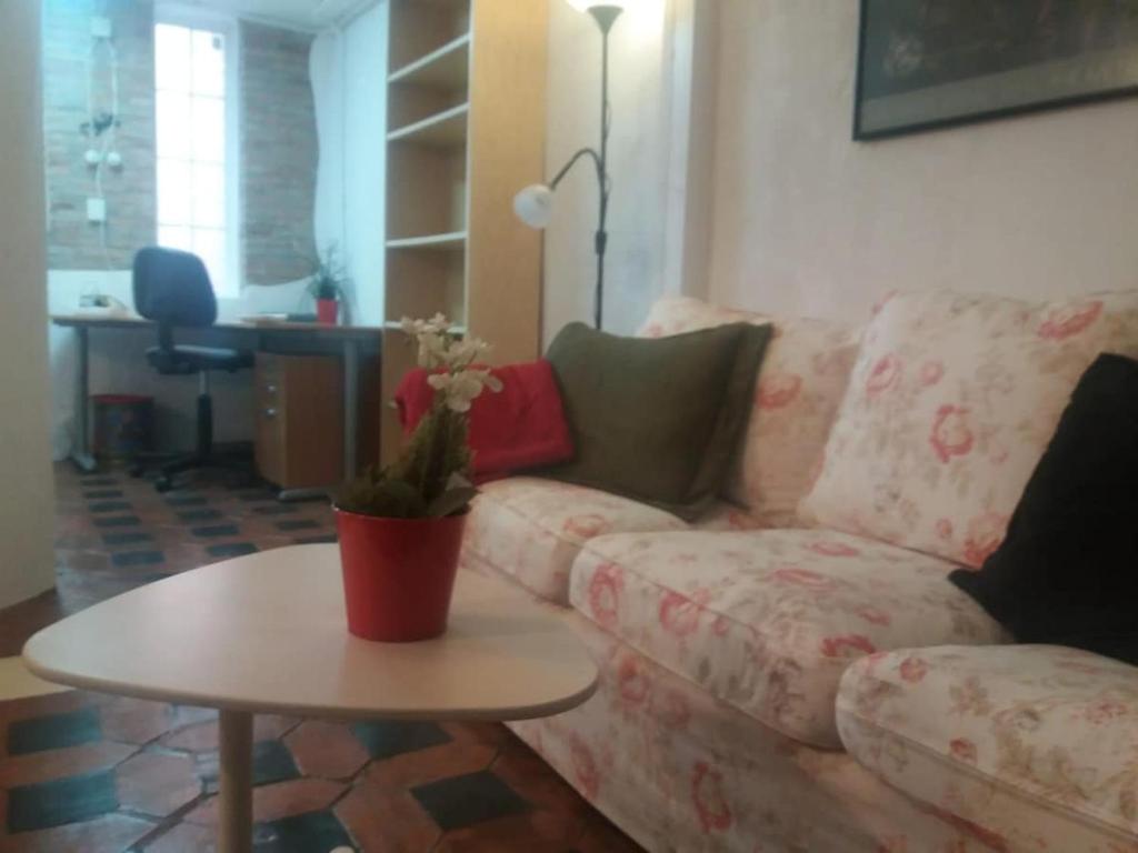 a living room with a couch and a table at The office 2020 in Tres Cantos