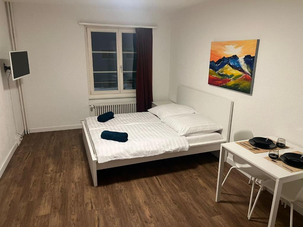 a small room with a bed and a table at Central Living Brugg - Studio 11 in Brugg