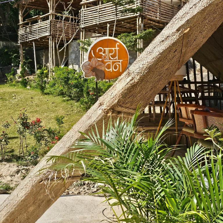 a sign on the side of a building with plants at Aaryavan, A boutique resort in Mount Ābu