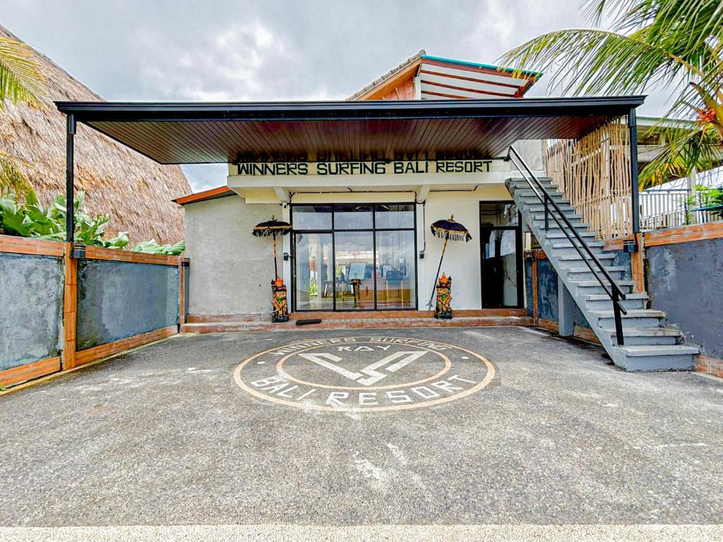 a building with a sign that says nurses starter bill issuer at Winners surfing bali resort in Airsatang