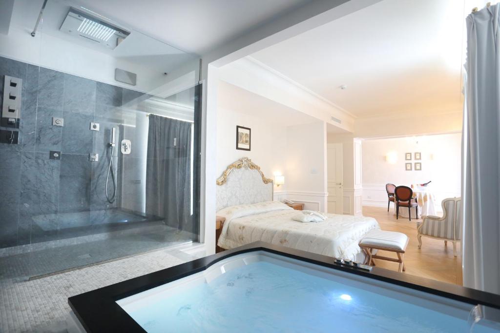 Postel nebo postele na pokoji v ubytování Tesoretto Hotel