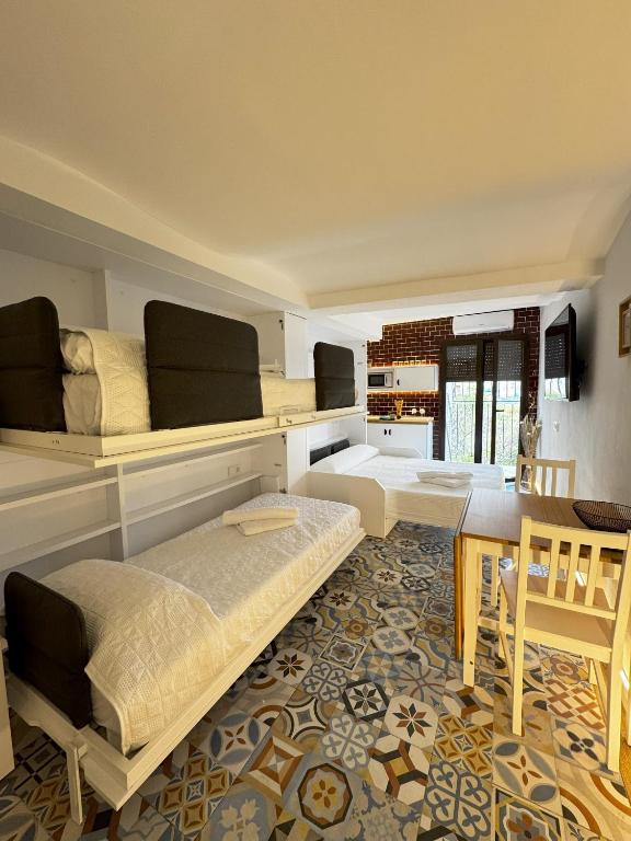 a living room with two beds and a table at Moscatel - Harbor's Light in Villajoyosa