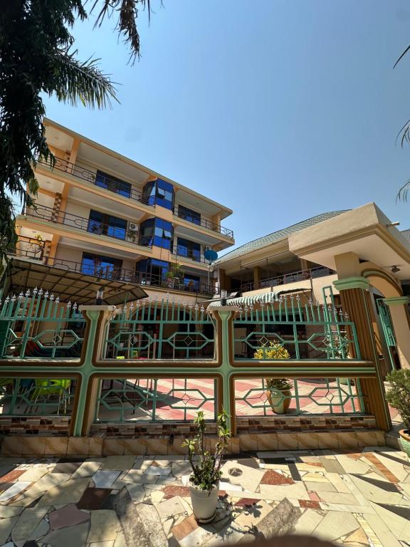 a building with a fence in front of it at Port Park Hotel in Mwanza