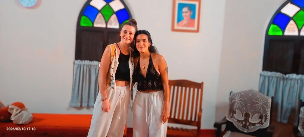 two women standing next to each other in a room at Anna's Heritage bungalow in Alleppey