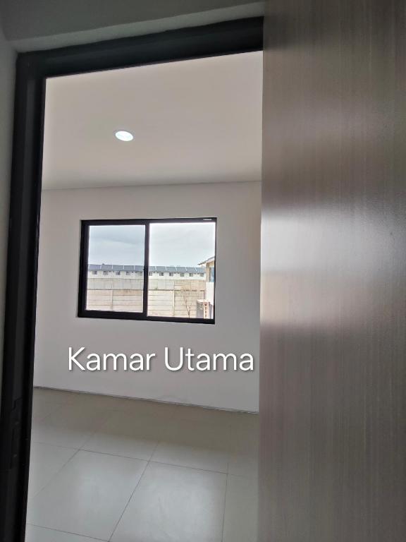 a room with a sign that reads kaminar urwana at Park Serpong Type XYZ Cluster Charm in Carangpulang