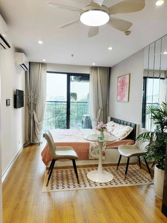 a bedroom with a bed and a table and chairs at Studio Ocean Park 0301 - toà S1 in Gia Lâm Pho