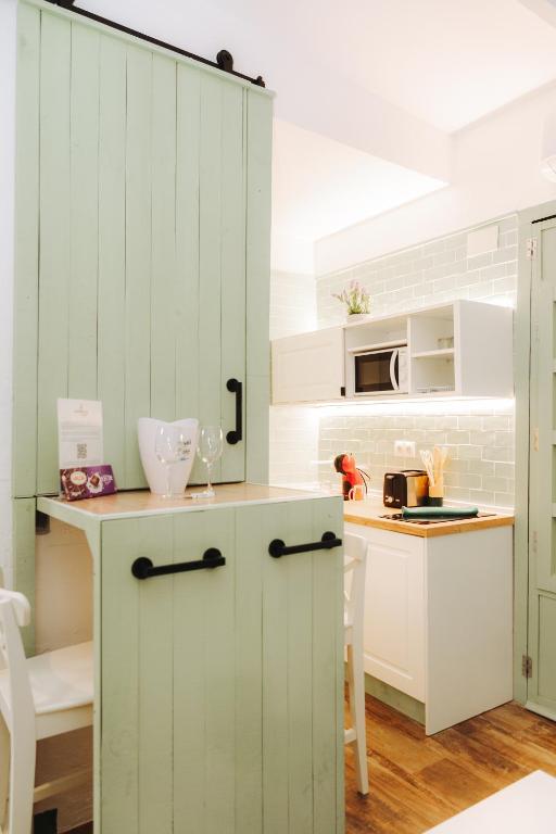 a kitchen with white cabinets and a counter top at Prieto Picudo - Harbor's Light in Villajoyosa