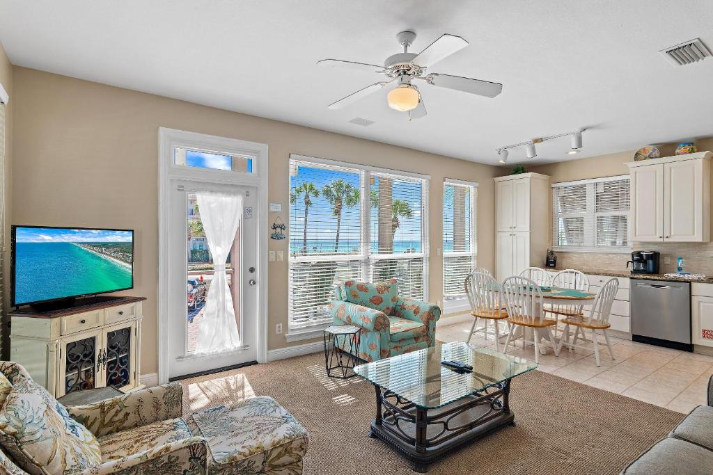 a living room with a television and a dining room at Destiny Beach Villas #9A in Destin