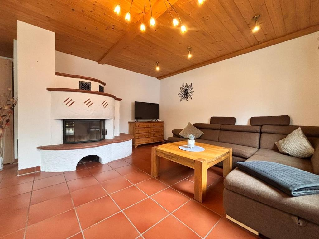 a living room with a couch and a fireplace at Ferienwohnung Buronia 2 in Kaufbeuren