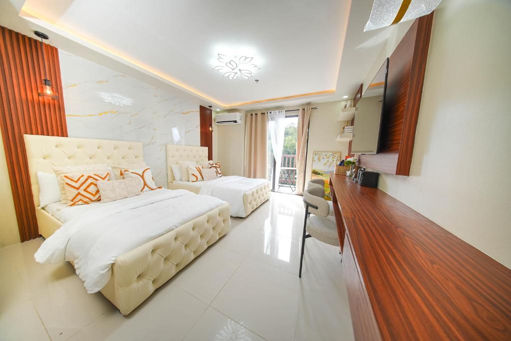 a bedroom with a large bed and a living room at Alpine Villas at Crosswinds Tagaytay Casa de Vela in Tagaytay