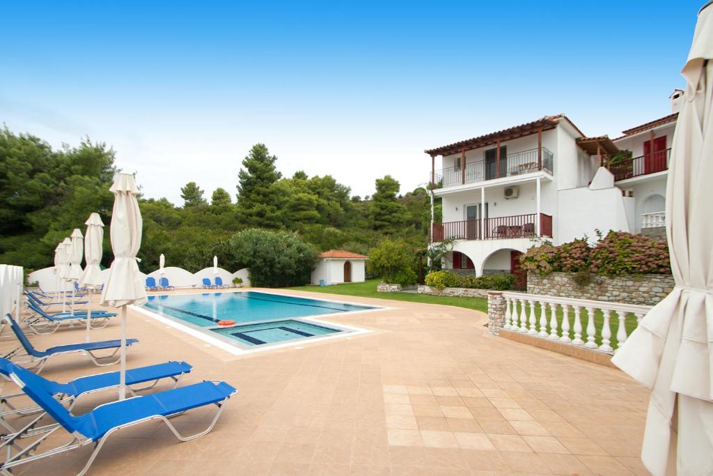 a villa with a swimming pool and a house at Villa Alissia in Koukounaries