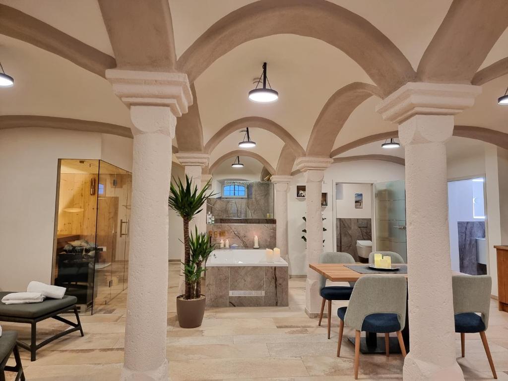a large room with columns and a bathroom with a tub at Privat SPA Premium Suite 117 qm in Wehlenberg