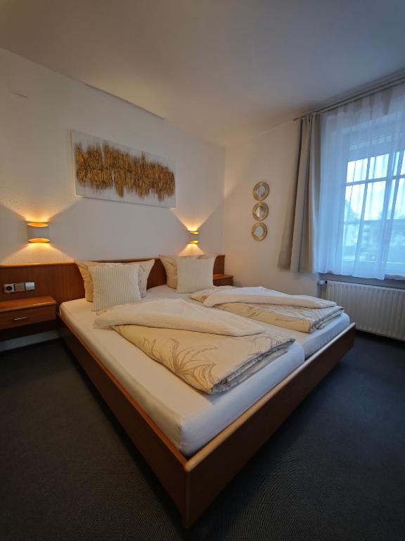 a large bedroom with two beds and a window at Pension Villa Sarah in Bad Dürrheim