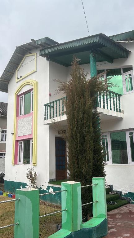 a house with a green bench in front of it at Karnai Residency in Srinagar