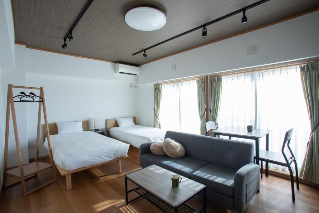 a living room with a couch and a bed at NIYS apartments 04 type in Tokyo