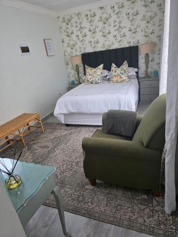 a bedroom with a bed and a couch and a chair at Pennington Splendor Apartment in Pennington