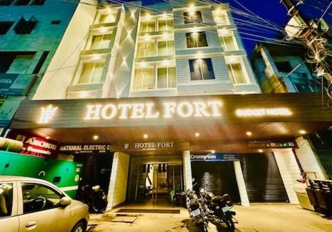 a hotel front with a car parked in front of it at Hotel Fort in Patna