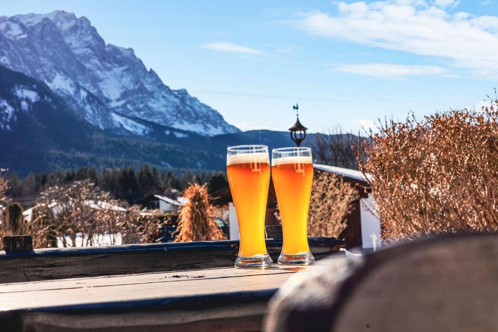 two glasses of beer sitting on top of a table at Gästehaus Florian in Grainau