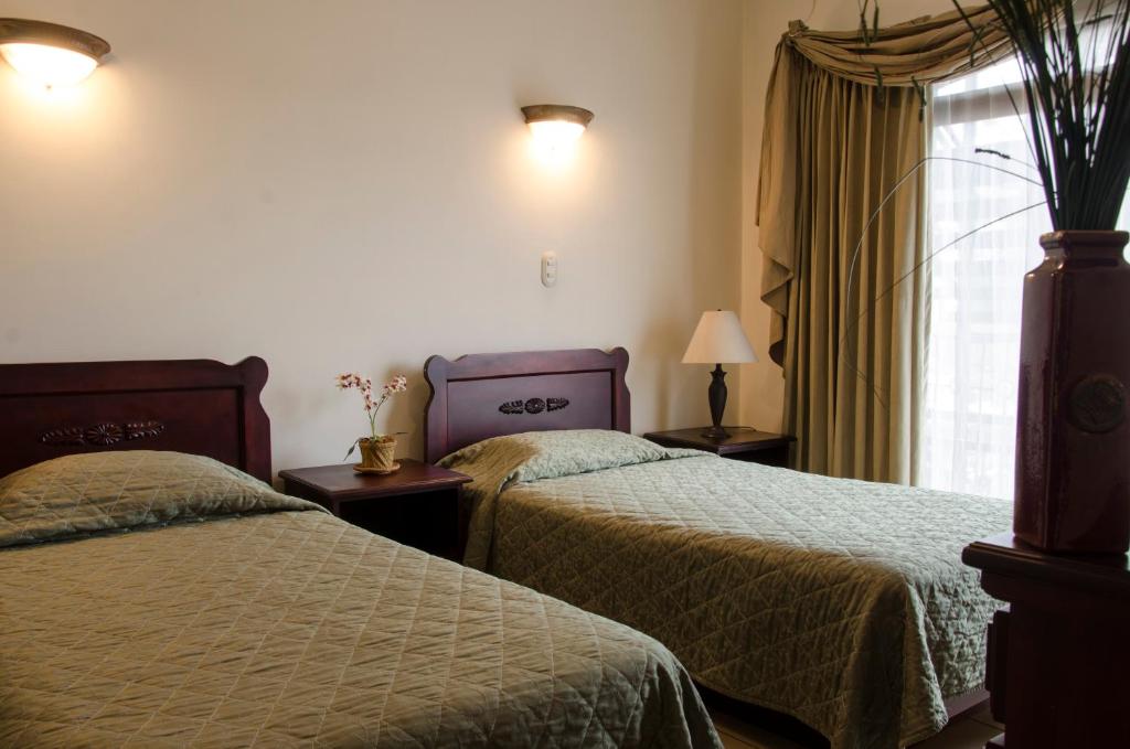 Postel nebo postele na pokoji v ubytování Hotel Plaza Real Suites & Apartments San Jose