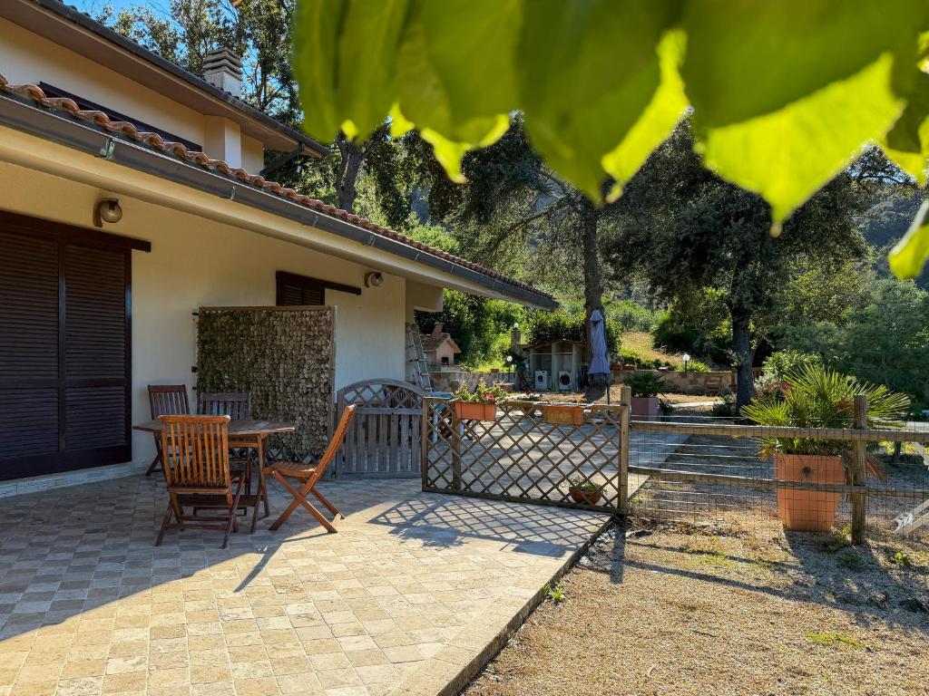 a patio of a house with a table and chairs at Casa Alessia , il tuo angolo di pace a Nisporto in Nisporto