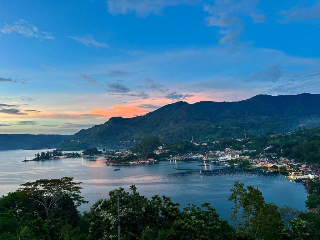 a view of a body of water with mountains at Toba Crest Vue in Parapat