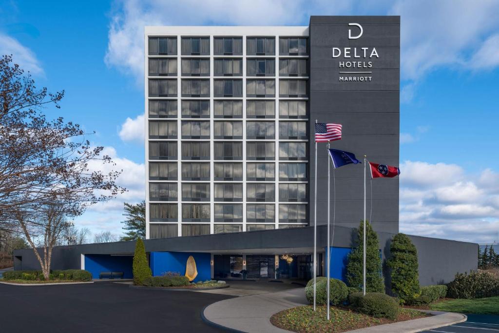 a hotel with two flags in front of a building at Delta Hotels by Marriott Nashville Airport in Nashville