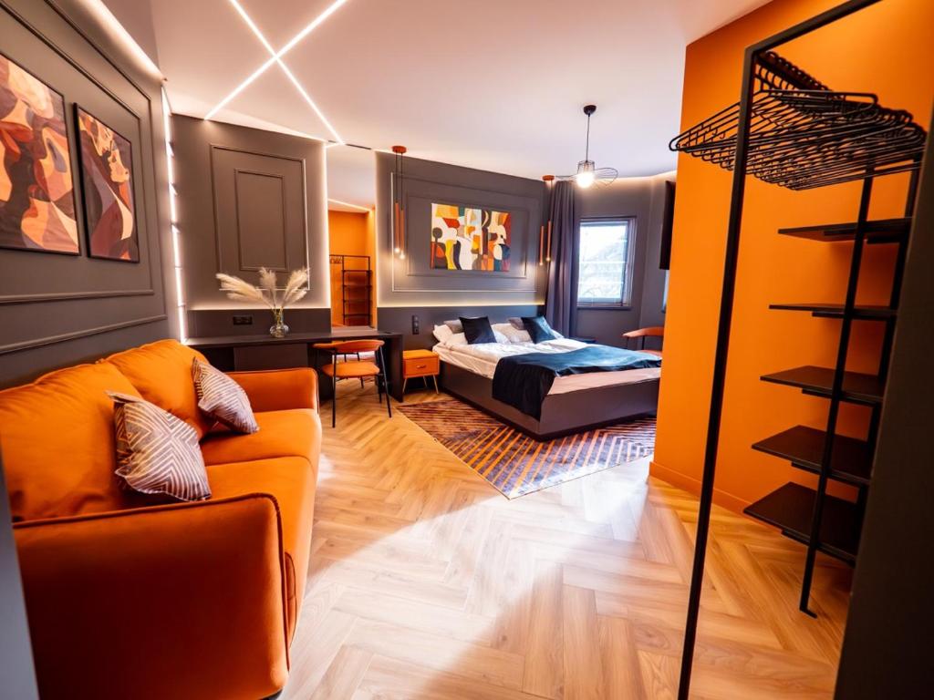 a living room with a couch and a bed at Premier Rooms in Szarvas