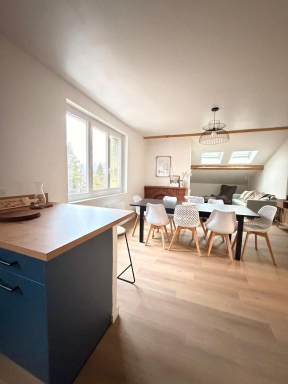 a kitchen and dining room with a table and chairs at La Bulle d Ax in Ax-les-Thermes