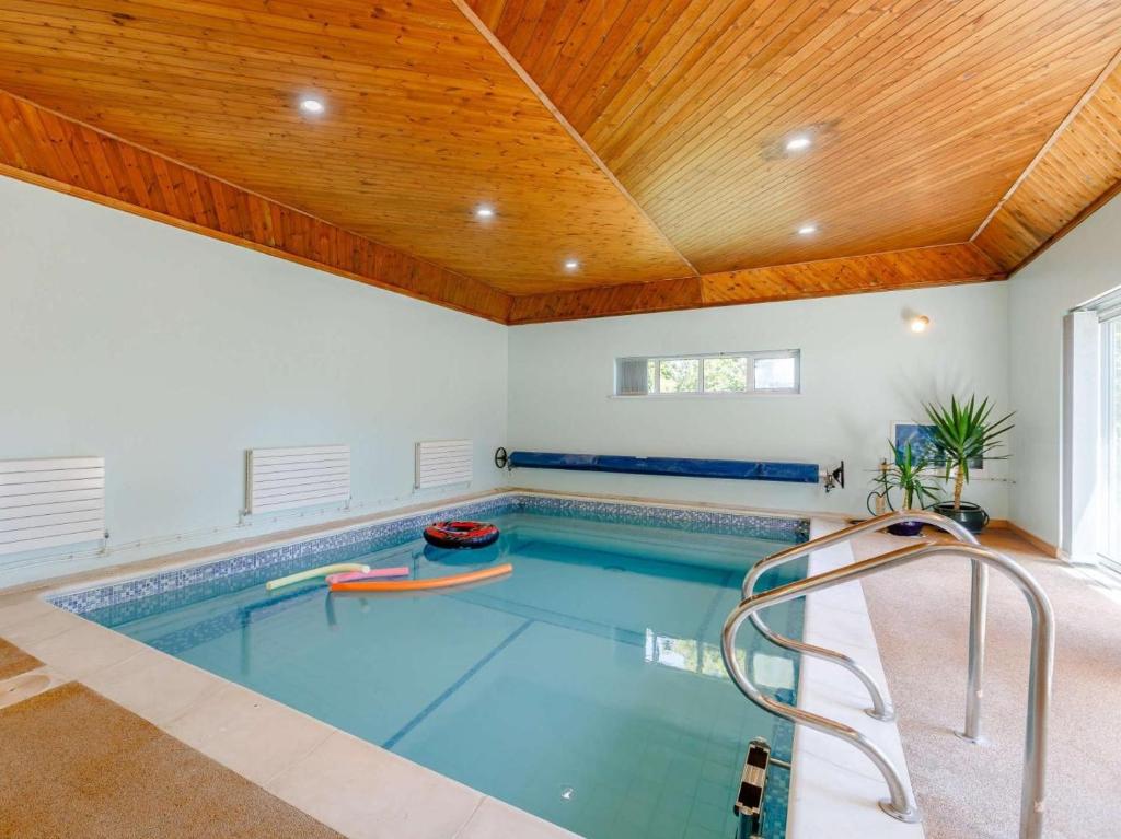 an indoor swimming pool with a wooden ceiling at 4 Bed in Southampton oc-82920 in Netley