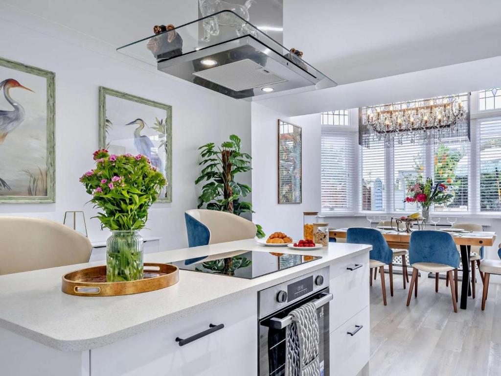 a kitchen with white counters and a table with chairs at 3 Bed in Shanklin oc-92053 in Shanklin