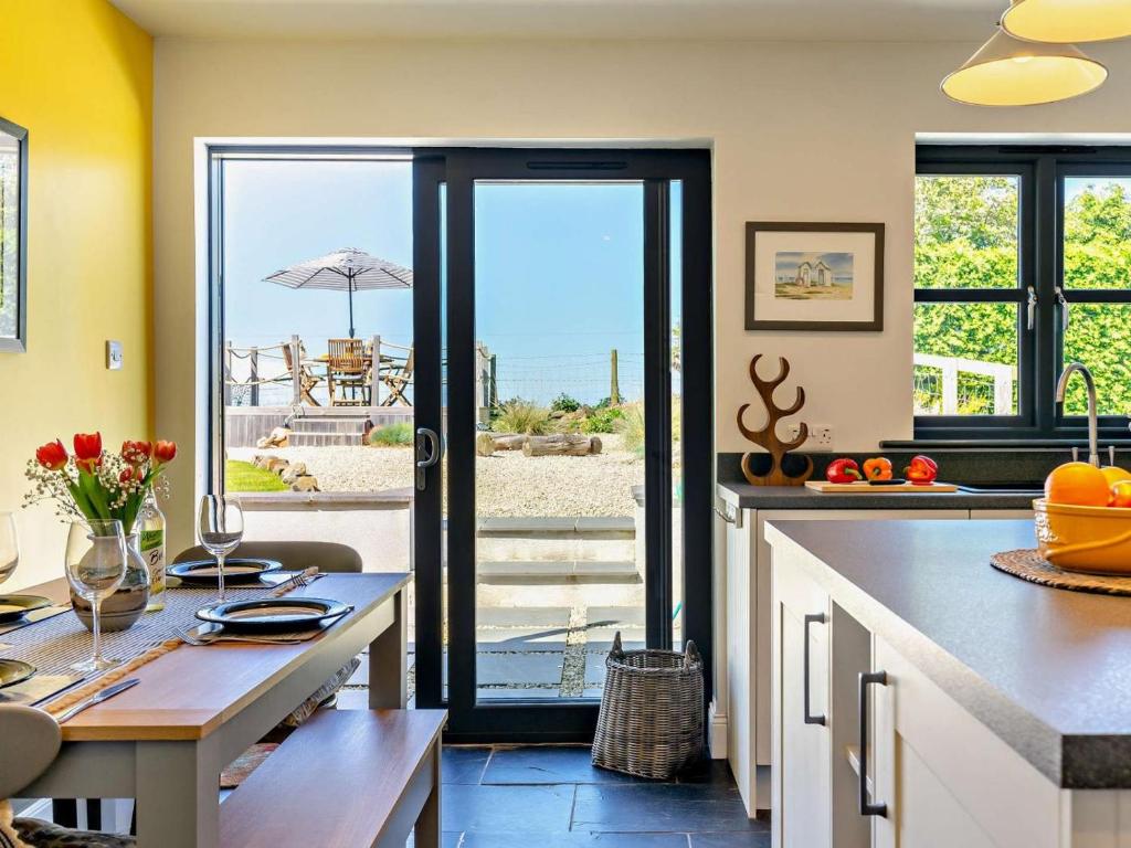 a kitchen with an open door to the beach at 2 Bed in Belford oc-92196 in Ellington