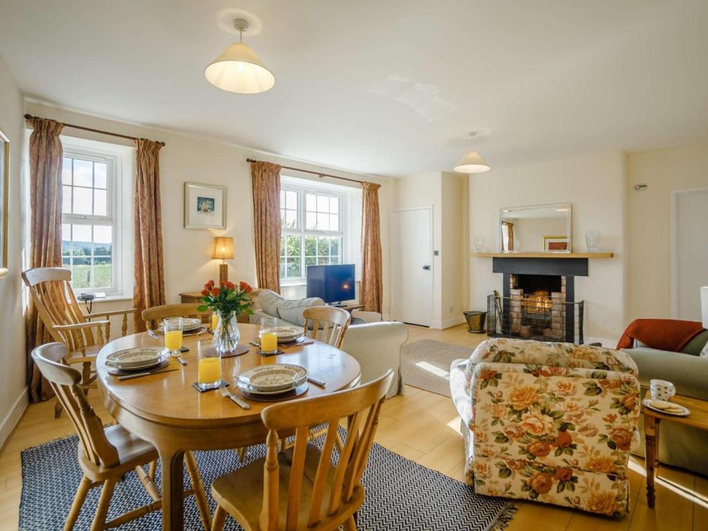 a living room with a table and chairs and a living room at 2 Bed in Mindrum oc-85422 in Carham