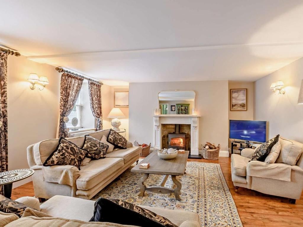 a living room with a couch and a fireplace at 3 Bed in Morpeth oc-61257 in Harbottle