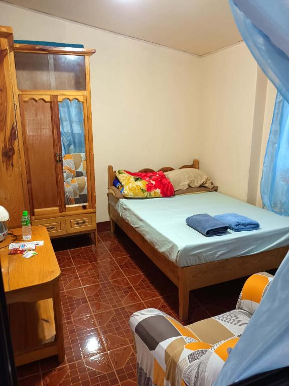 a small bedroom with two beds and a table at RD's Apartment in Eyeb, Poblacion, Bontoc in Bontoc