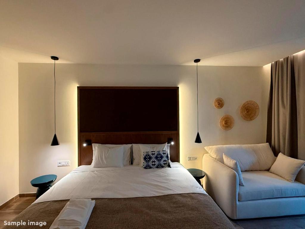 a bedroom with a bed and a couch at ROBINSON BOA VISTA - All inclusive in Sal Rei