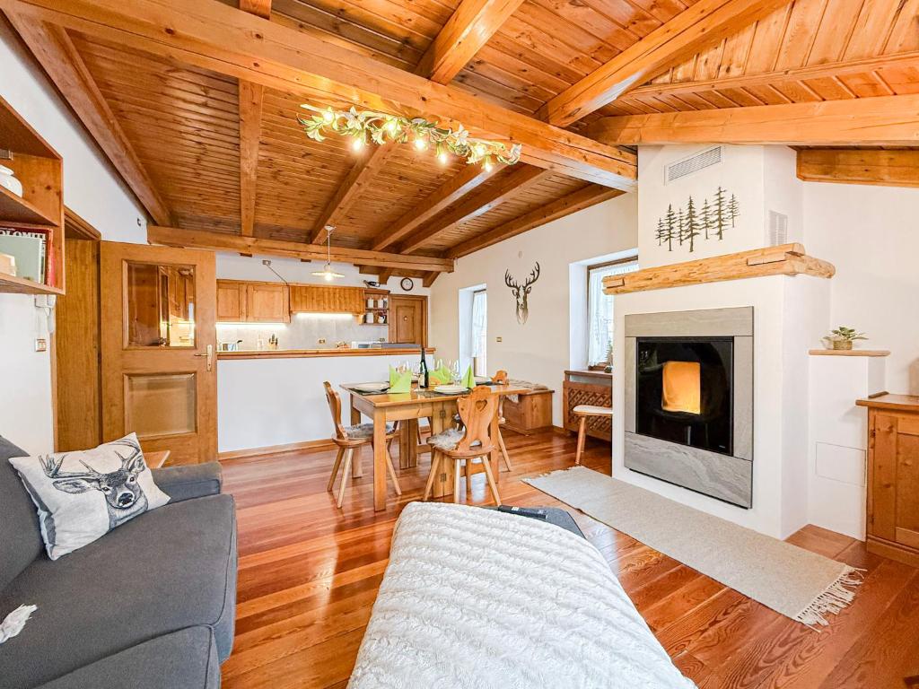 a living room with a table and a fireplace at Belvedere Solferino panoramic view in Campolongo