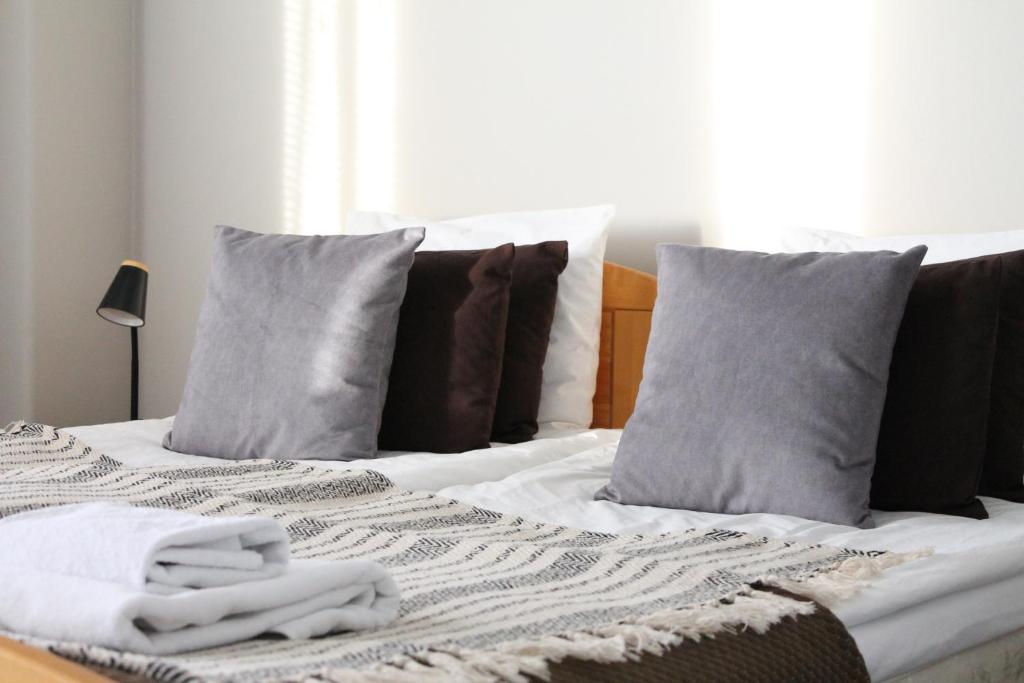 a bed with towels and pillows on top of it at Scandinavian Dream Guesthouse and Apartments in Rovaniemi