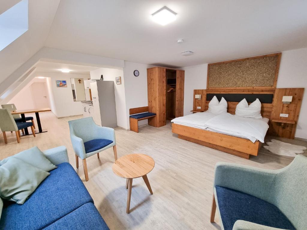 a hotel room with a bed and two chairs and a table at Apartment "Storch" in Wehlenberg