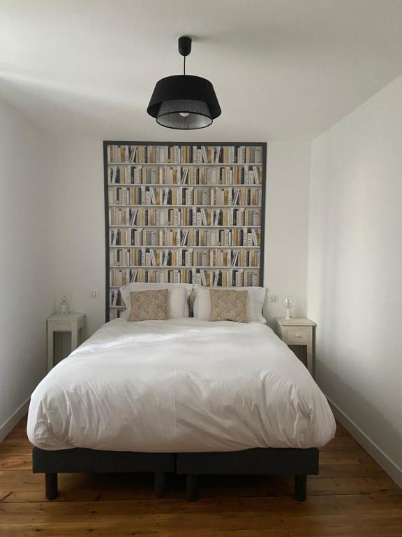 a bedroom with a large bed with a large headboard at Sylo-V CHAMBRE EDGAR in Gensac-la-Pallue