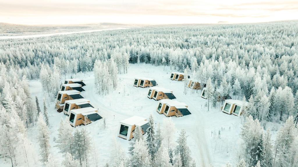 an aerial view of a resort in the snow at Lapland Glow Chalets in Rovaniemi