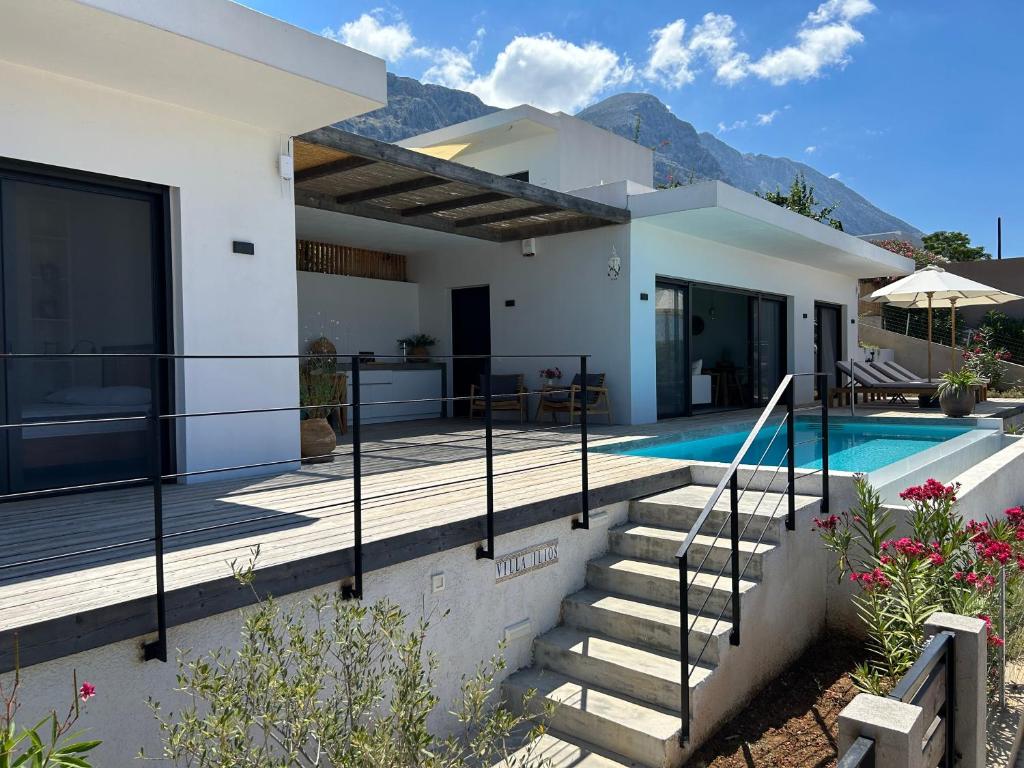 a villa with a swimming pool and a house at Villa Ilios in Paleros