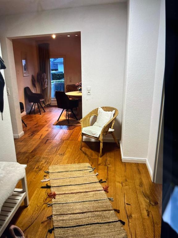 a living room with a table and chairs and a rug at Ferienwohnung Benz in Löningen